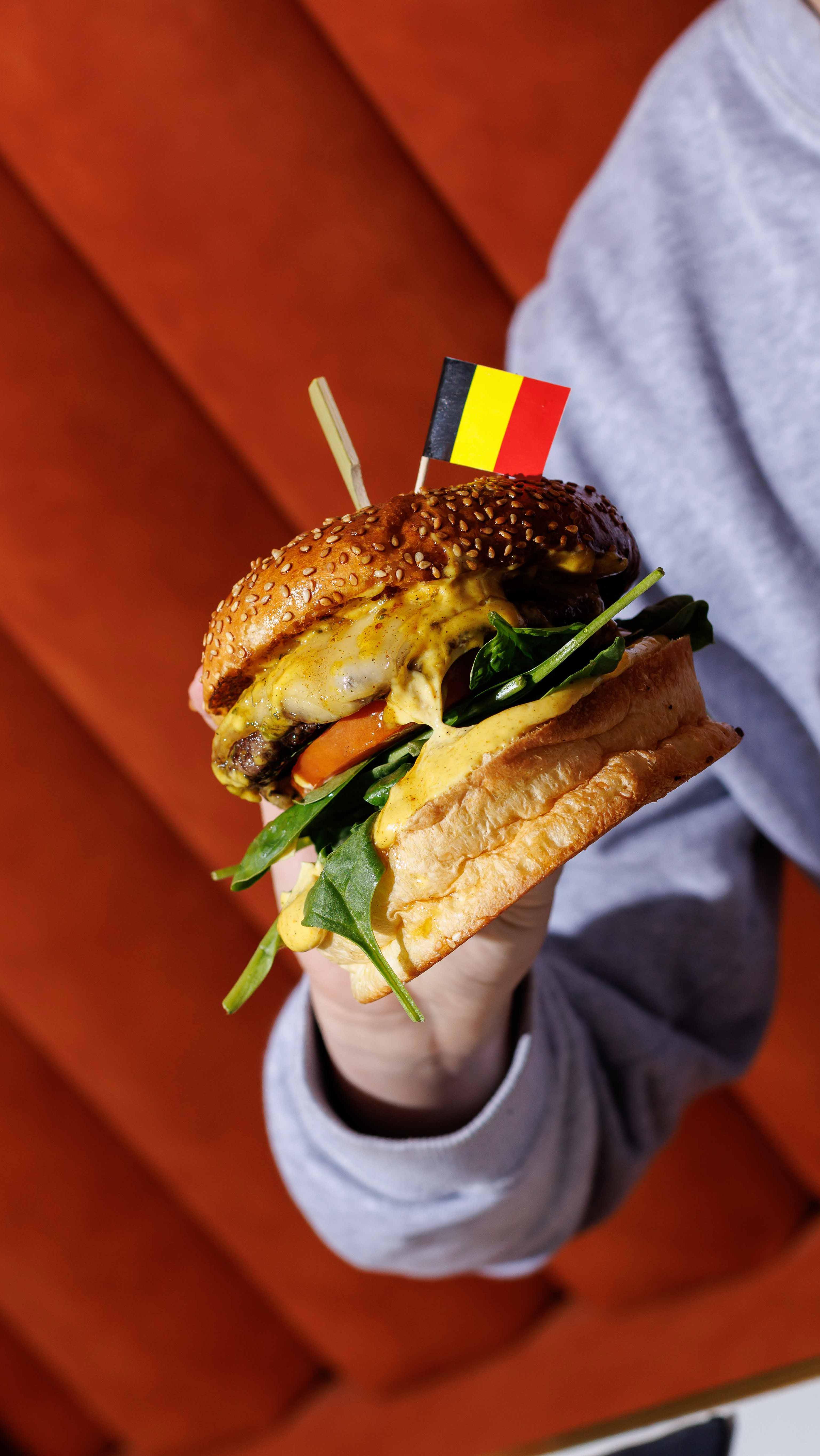 A box of fries with a white sauce on top.