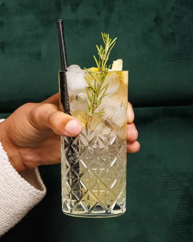 A box of french fries with a white sauce on top.